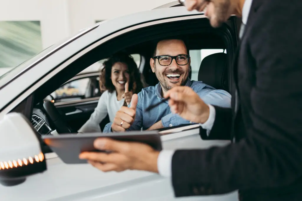 Middle,Age,Couple,Choosing,And,Buying,Car,At,Car,Showroom.