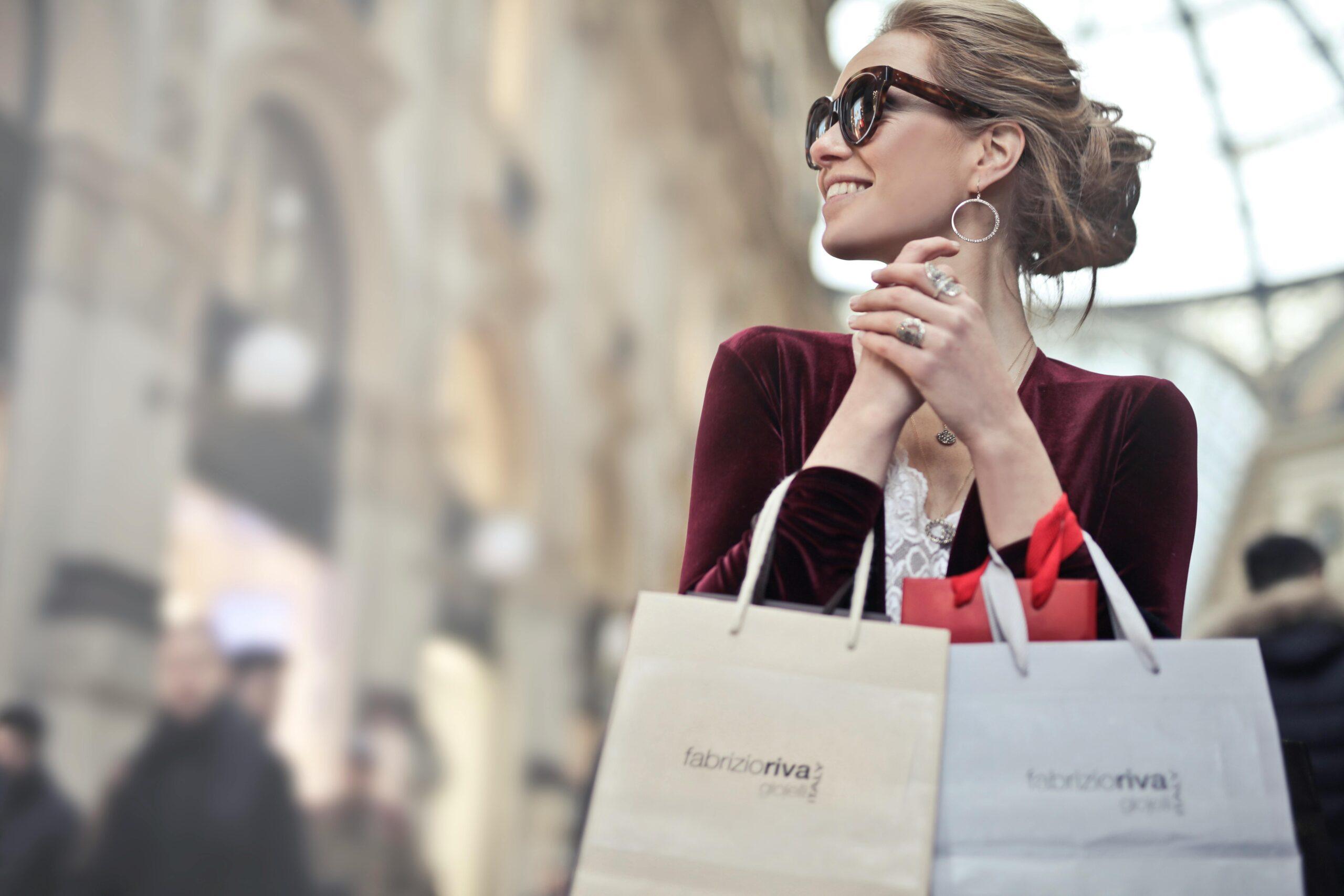 Smiling holiday shopper carrying bags, symbolizing how data enrichment transforms customer records into valuable insights that drive seasonal marketing success.