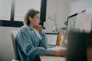 A,Woman,Looking,At,Charts,And,Graphs,On,A,Computer