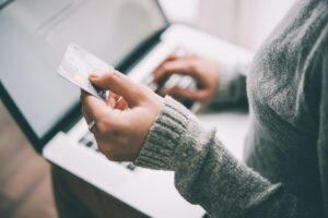 Hands,Holding,Plastic,Credit,Card,And,Using,Laptop.,Online,Shopping